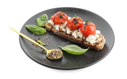 Photo of Delicious ricotta bruschetta with sun dried tomatoes, sauce, basil and milled pepper isolated on white