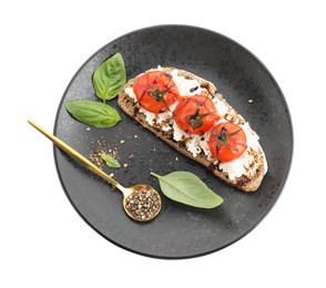 Photo of Delicious ricotta bruschetta with sun dried tomatoes, sauce, basil and milled pepper isolated on white, top view