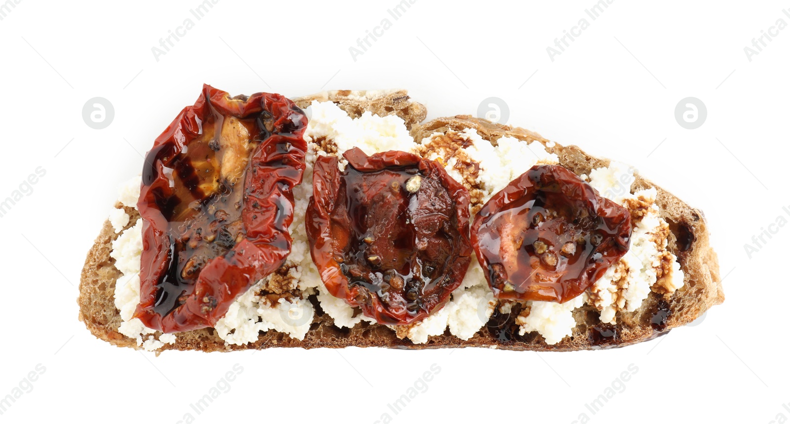 Photo of Delicious ricotta bruschetta with sun dried tomatoes and sauce isolated on white, top view