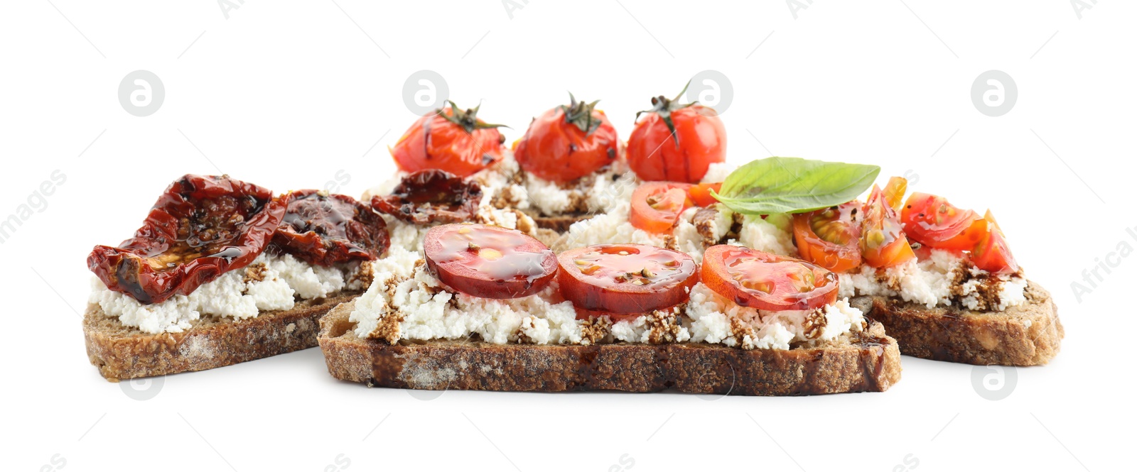 Photo of Delicious ricotta bruschettas with tomatoes, basil and sauce isolated on white