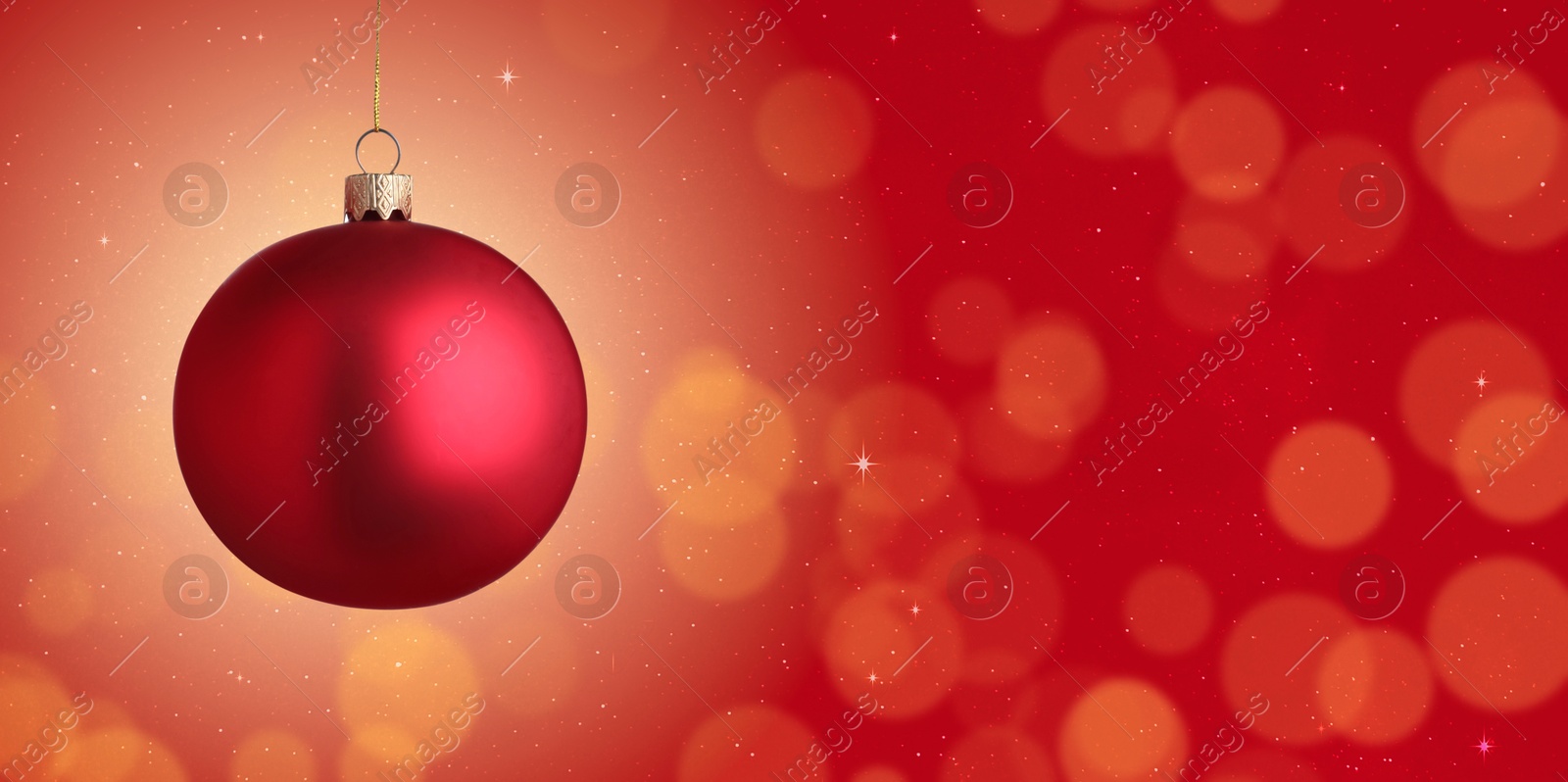 Image of Christmas ball against blurred red background with bokeh effect, space for text. Banner design