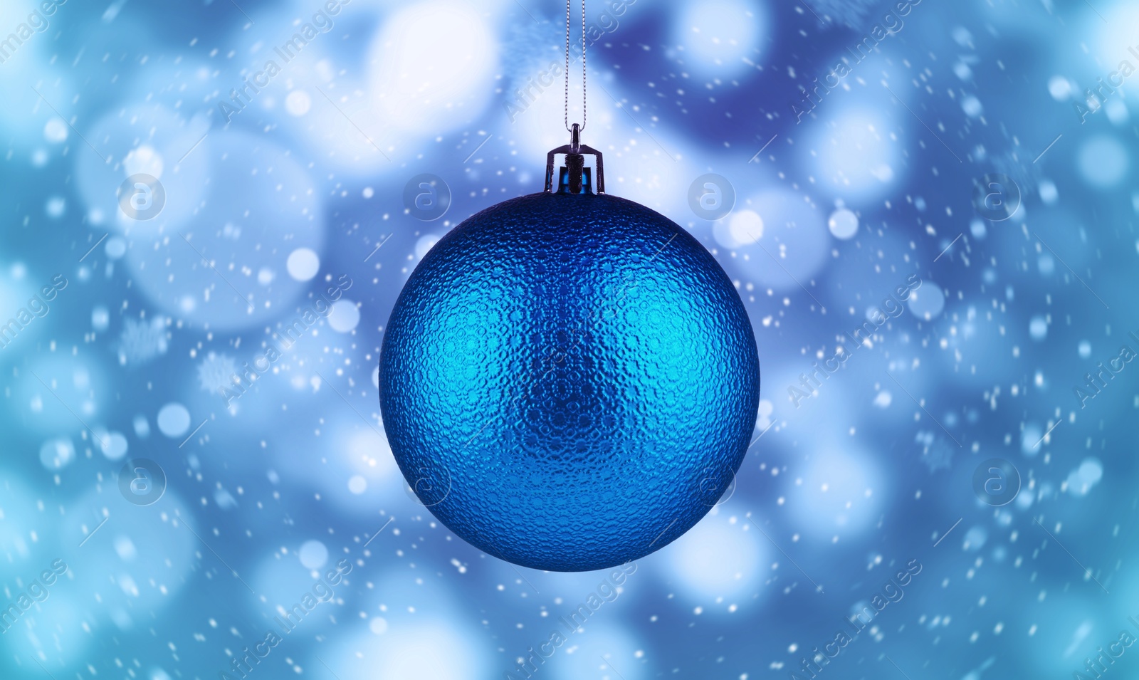 Image of Christmas ball against blurred background with bokeh effect. Banner design