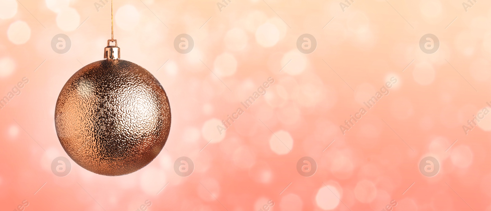 Image of Christmas ball against blurred background with bokeh effect, space for text Banner design