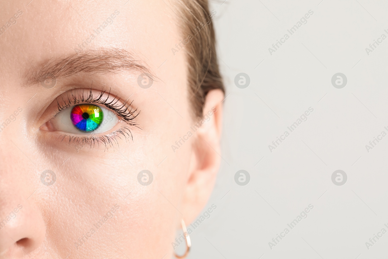 Image of Woman's eye toned in rainbow colors, closeup