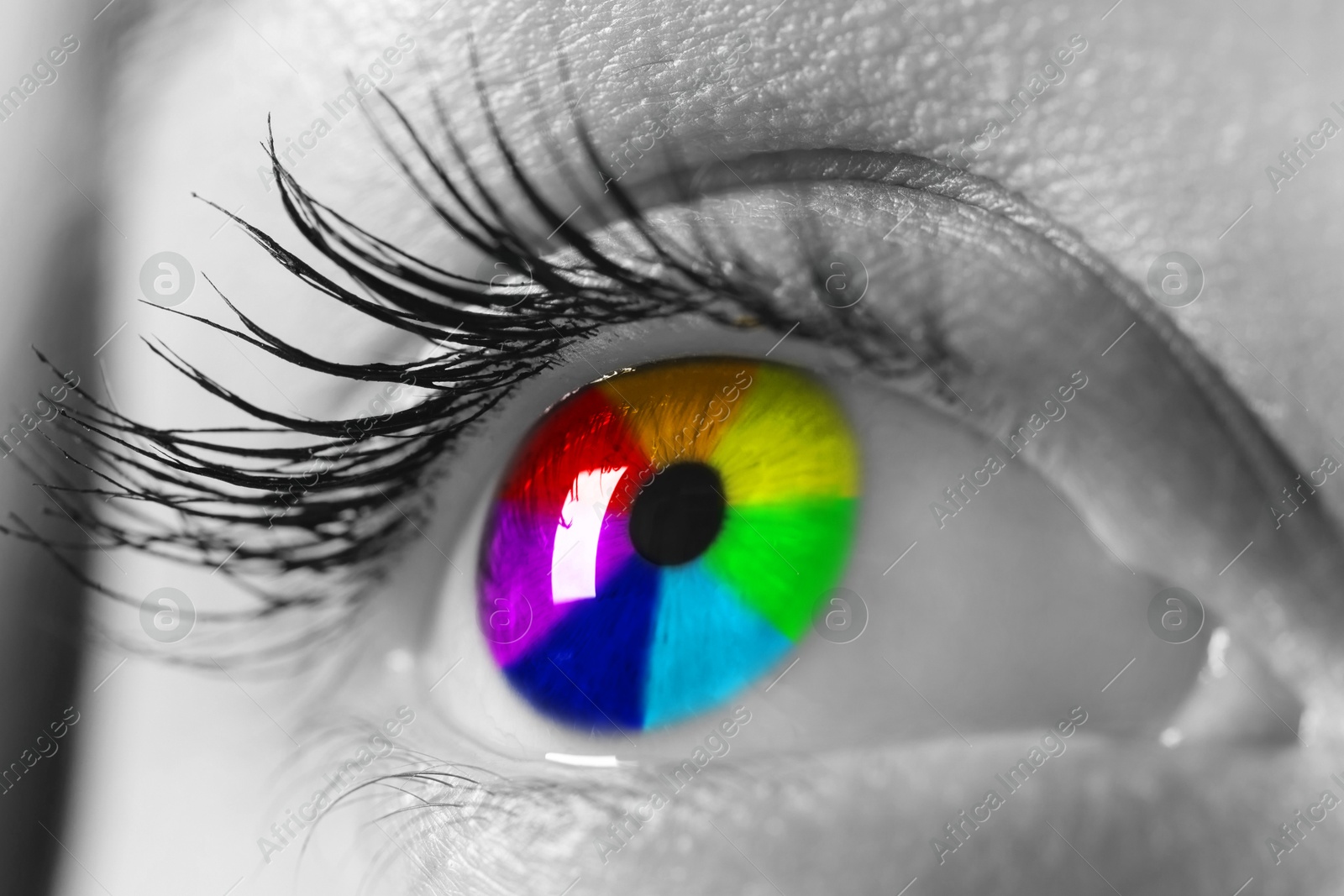 Image of Woman's eye toned in rainbow colors, closeup