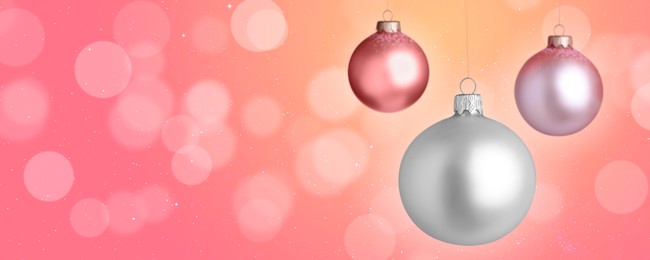 Image of Christmas balls against blurred background with bokeh effect, space for text. Banner design