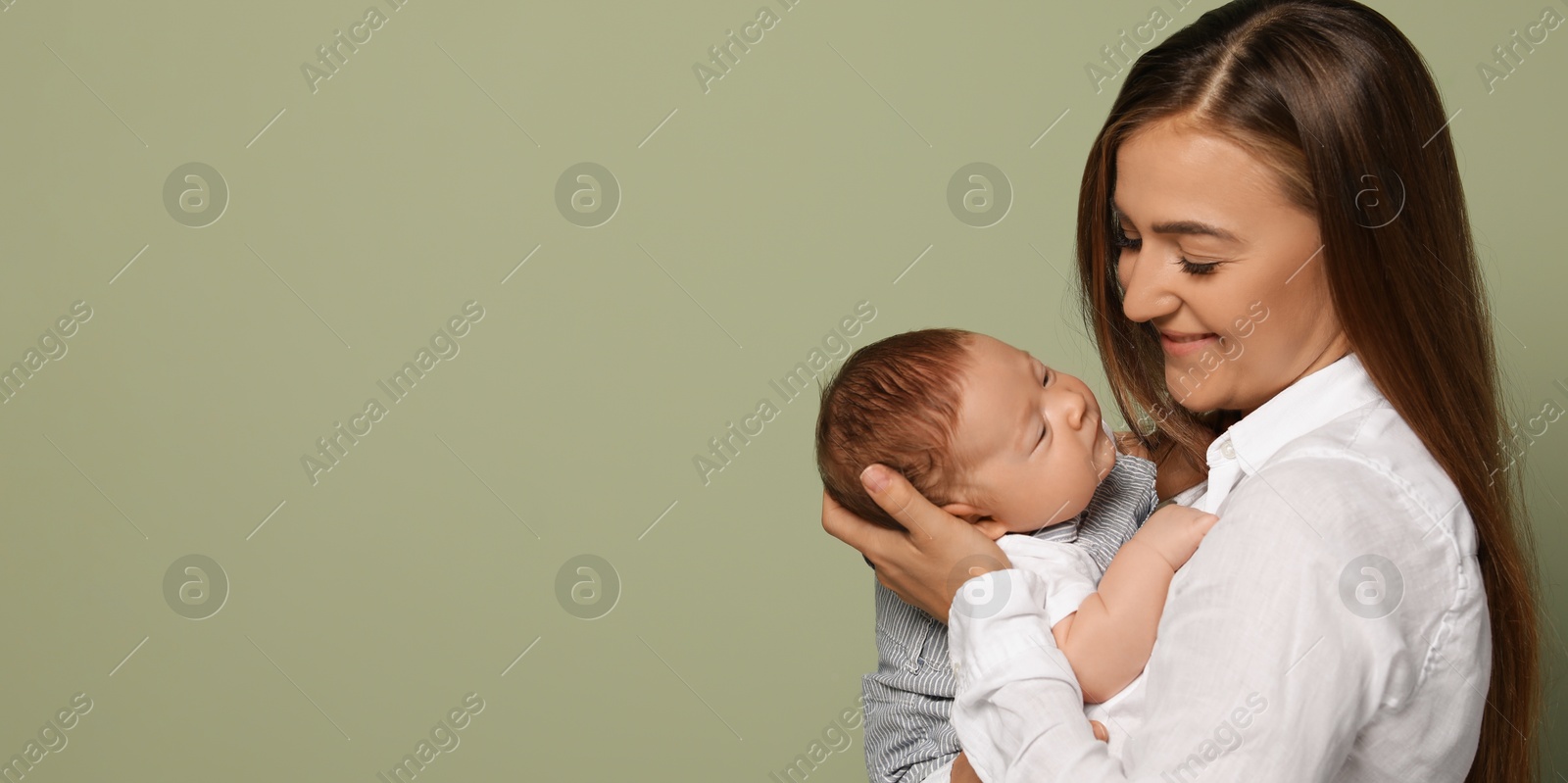Image of Mother holding her small baby on olive background. Banner design with space for text