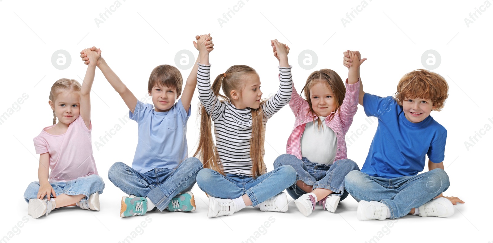 Photo of Group of cute children holding hands on white background