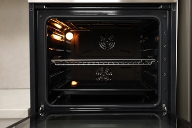 Photo of Open electric oven in kitchen. Cooking appliance