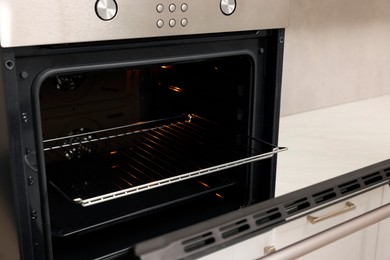 Photo of Open electric oven in kitchen. Cooking appliance