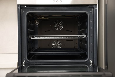 Photo of Open electric oven in kitchen. Cooking appliance