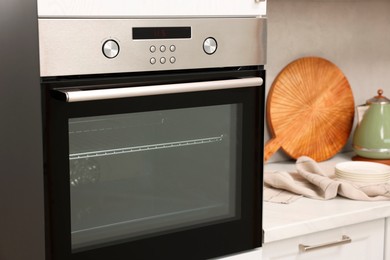 Photo of New electric oven in kitchen. Cooking appliance