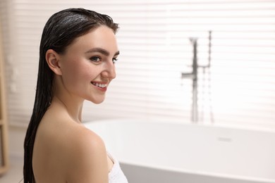 Photo of Smiling woman with applied hair mask in bathroom. Space for text