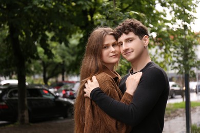 Photo of International dating. Lovely young couple spending time together outdoors, space for text