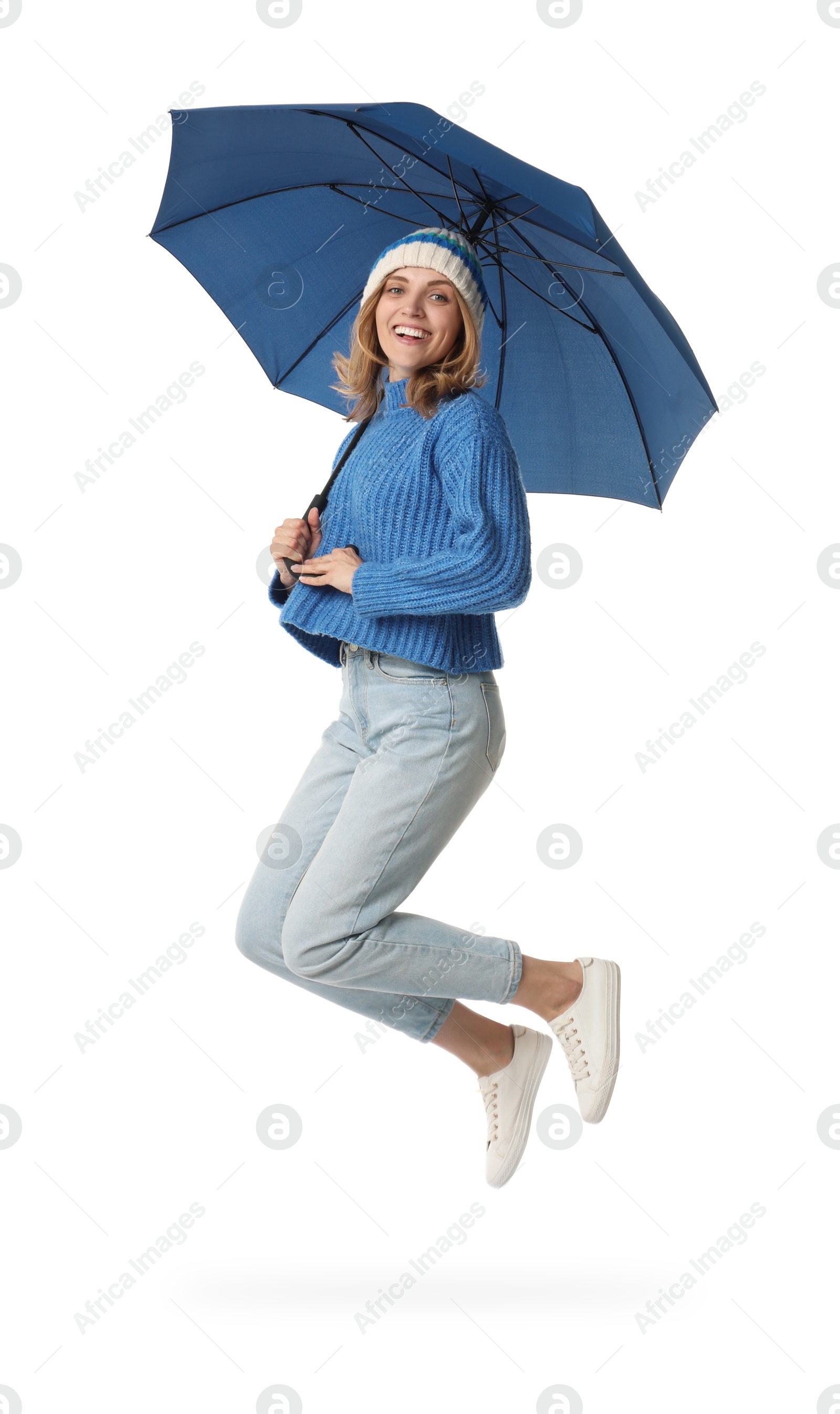 Photo of Woman with blue umbrella jumping on white background