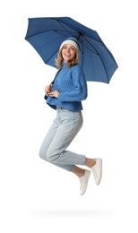 Woman with blue umbrella jumping on white background