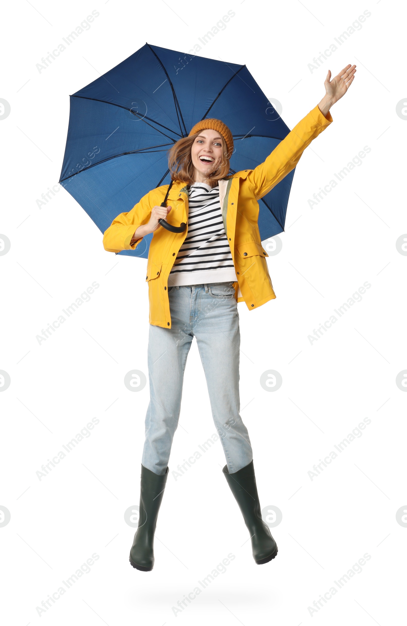 Photo of Woman with blue umbrella jumping on white background