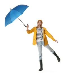 Photo of Woman with blue umbrella jumping on white background
