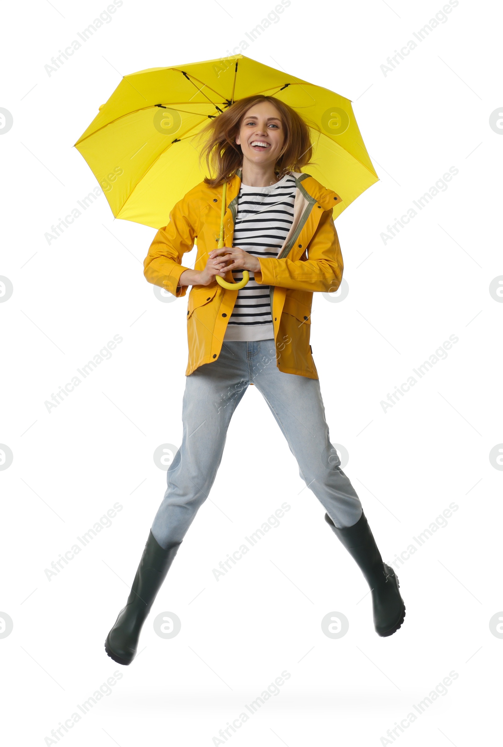 Photo of Woman with yellow umbrella jumping on white background