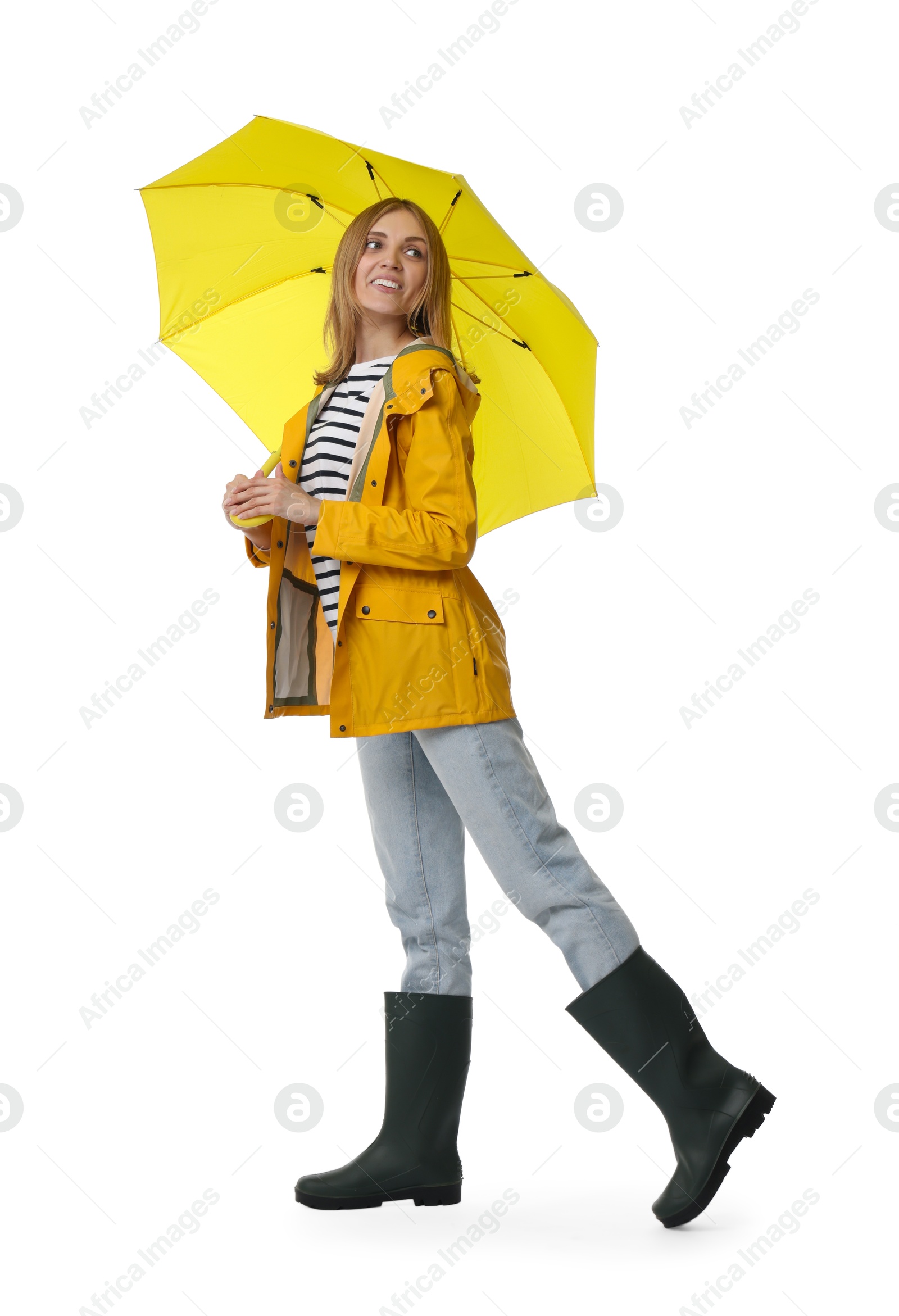 Photo of Woman with yellow umbrella walking on white background