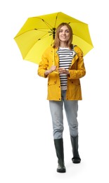 Photo of Woman with yellow umbrella walking on white background