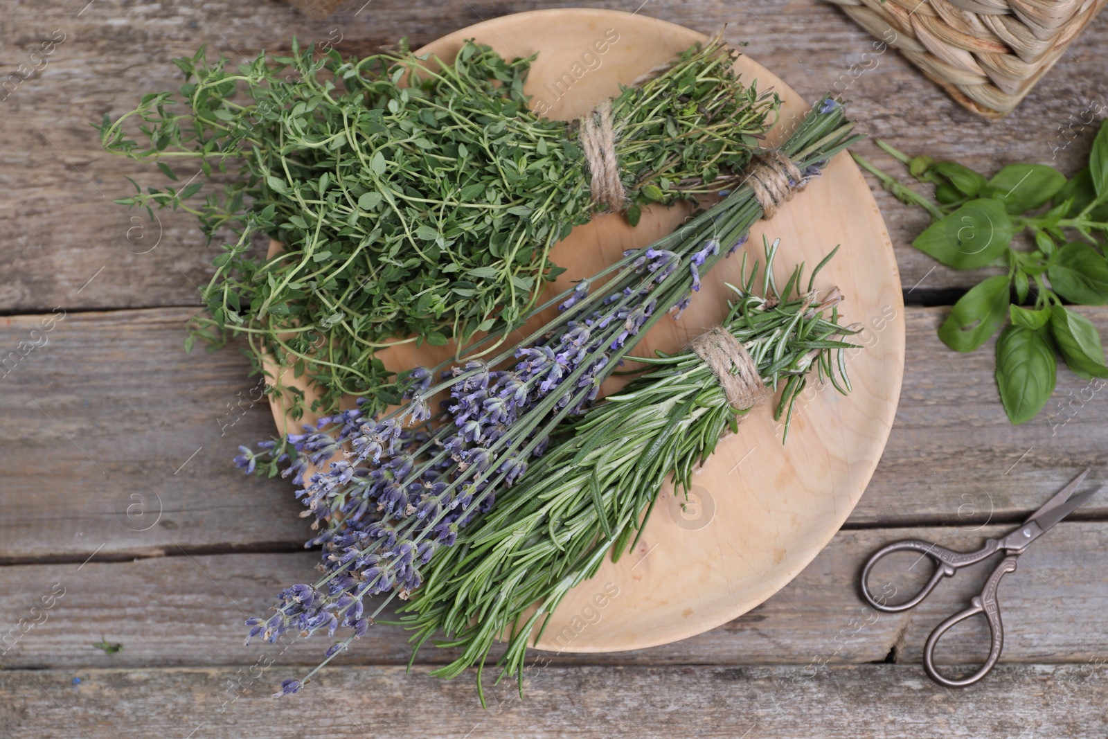 Photo of Different aromatic herbs and scissors on wooden table, flat lay