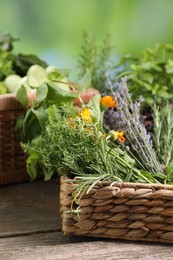 Photo of Different aromatic herbs on wooden table against blurred background, closeup