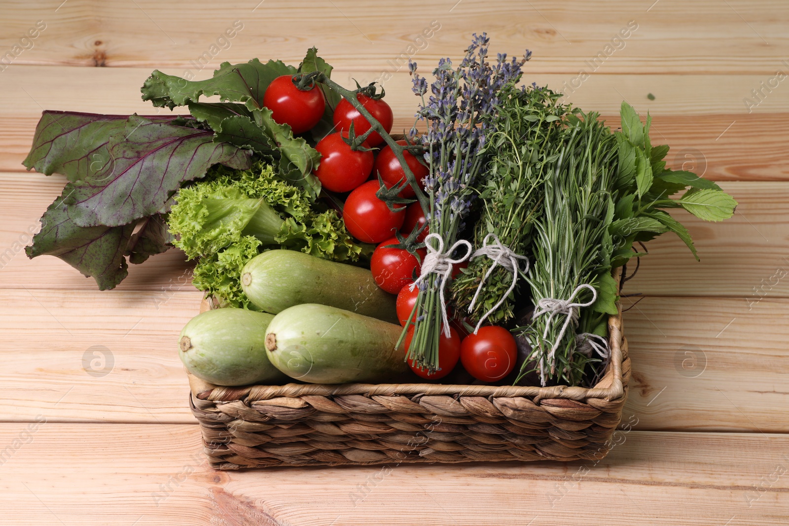 Photo of Different aromatic herbs and vegetables on wooden table