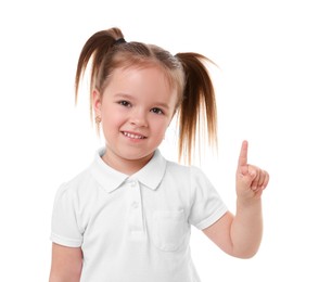 Portrait of cute little girl pointing at something on white background