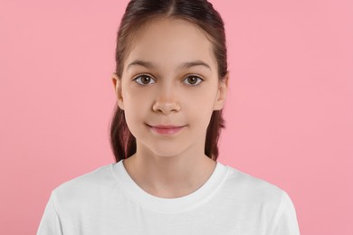 Photo of Portrait of beautiful girl on pink background
