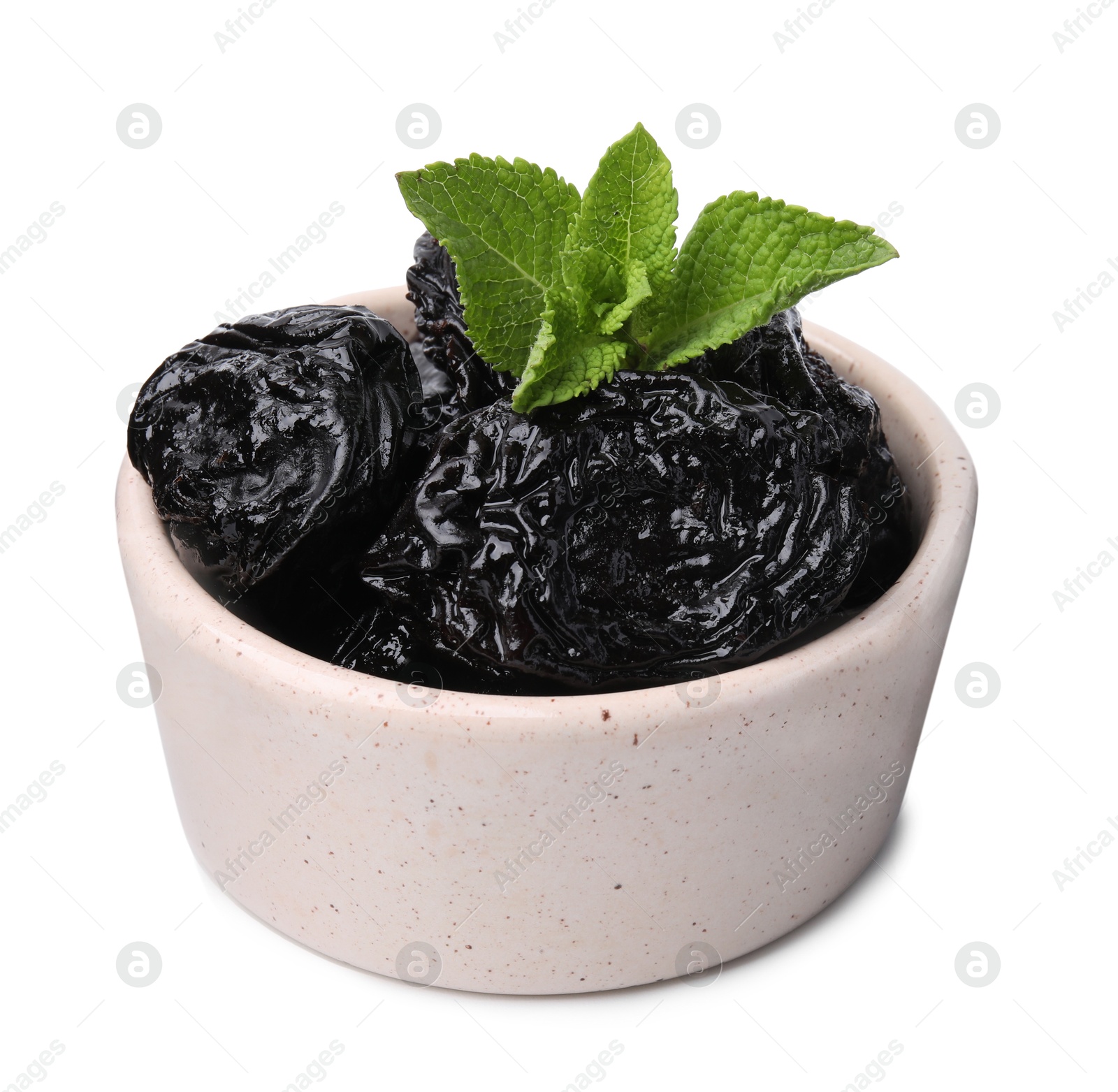 Photo of Tasty dried plums (prunes) and mint leaves in bowl on white background