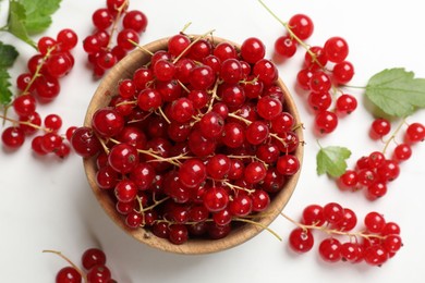 Photo of Fresh red currant berries in bowl on white table, top view