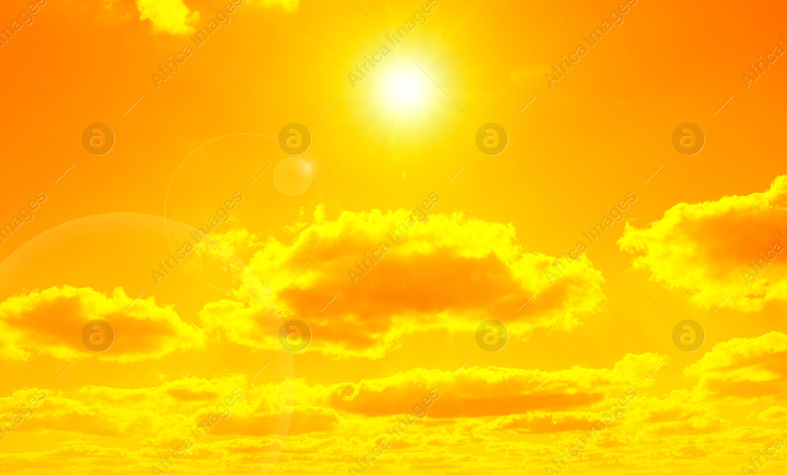 Image of Orange sky with sun and clouds during hot summer weather