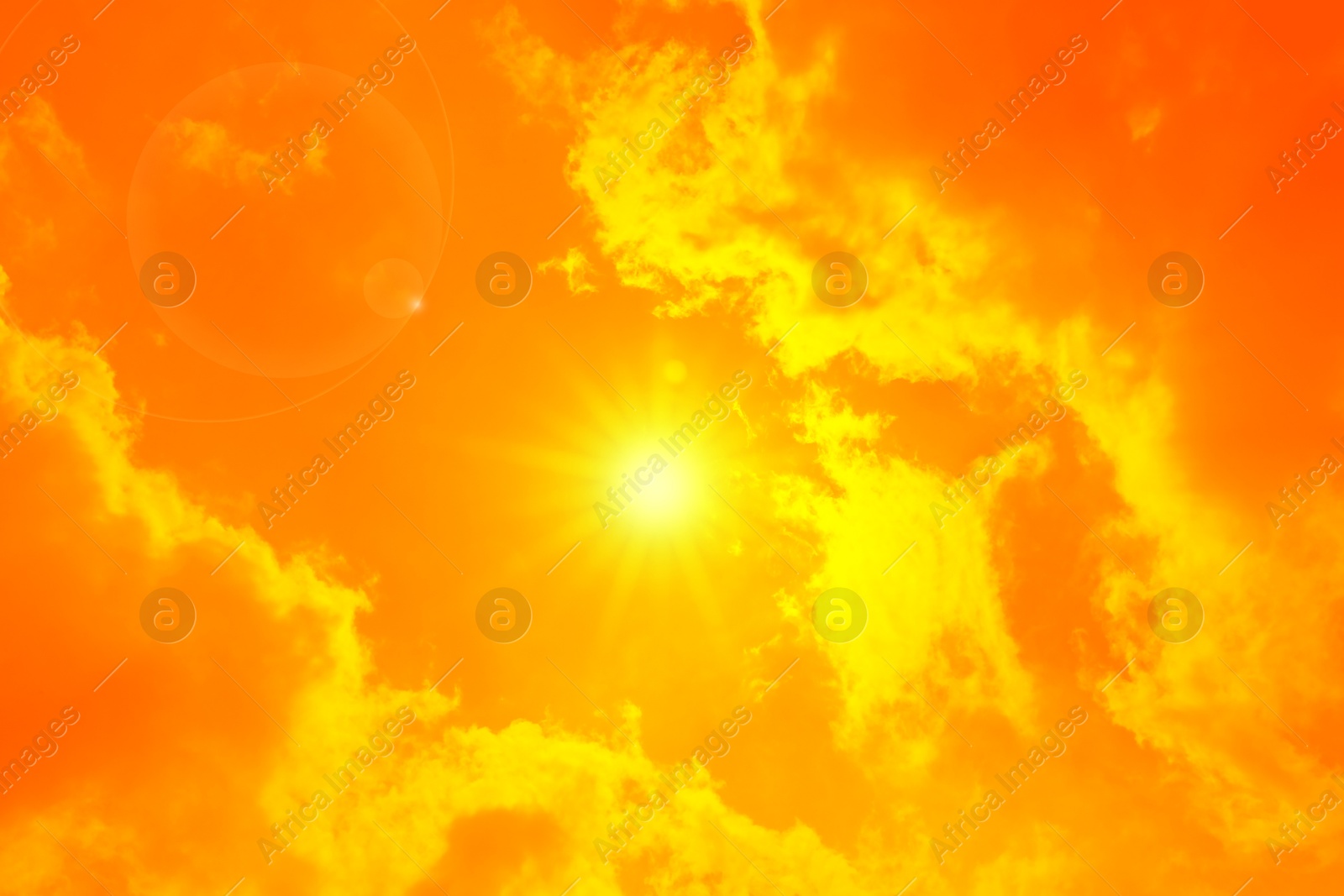 Image of Orange sky with sun and clouds during hot summer weather