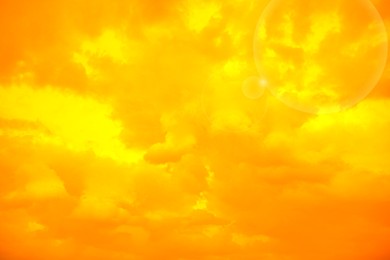 Image of Orange sky with clouds during hot summer weather