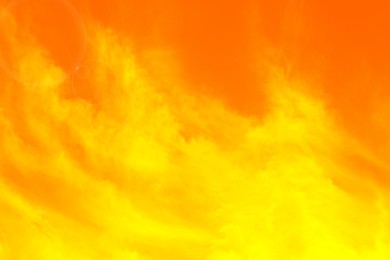 Image of Orange sky with clouds during hot summer weather