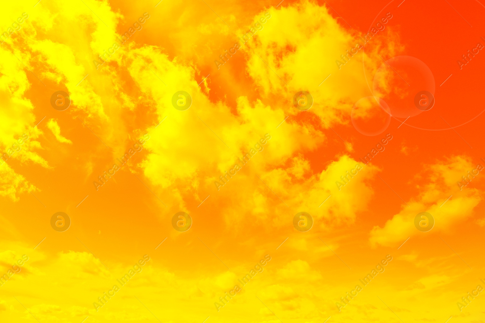 Image of Orange sky with clouds during hot summer weather