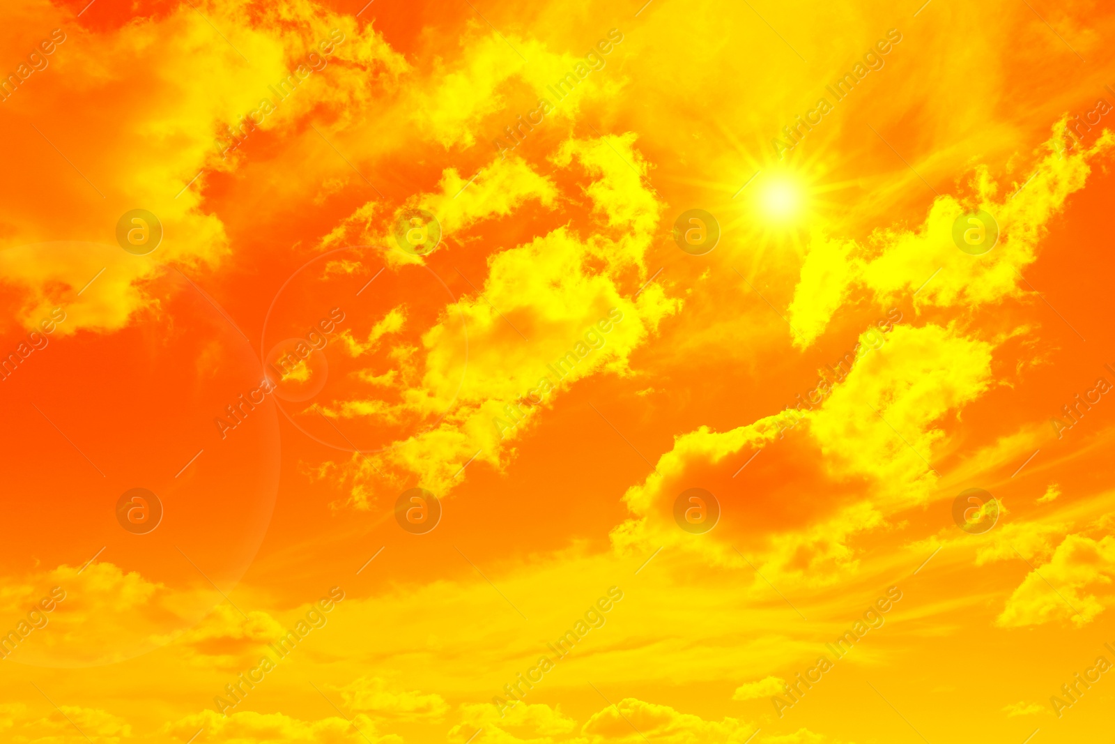 Image of Orange sky with sun and clouds during hot summer weather