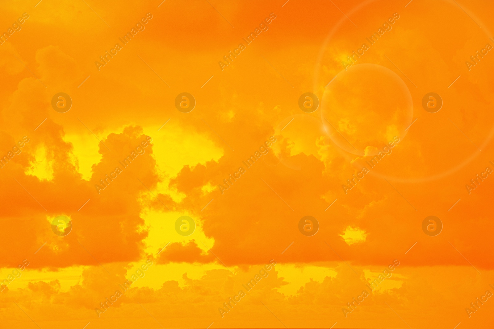 Image of Orange sky with clouds during hot summer weather