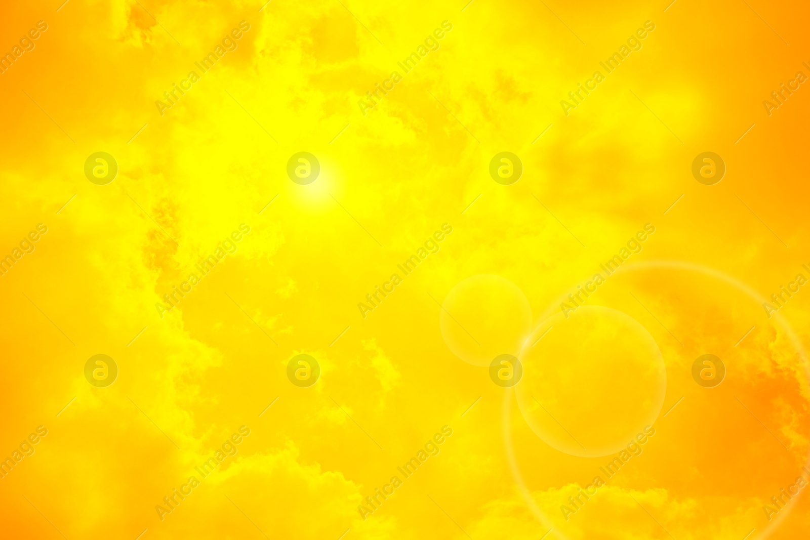 Image of Orange sky with sun and clouds during hot summer weather