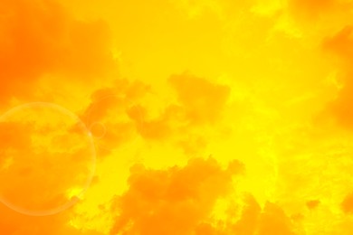 Image of Orange sky with clouds during hot summer weather