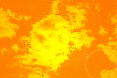 Image of Orange sky with clouds during hot summer weather