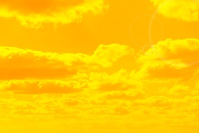 Image of Orange sky with clouds during hot summer weather