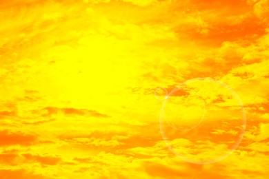 Image of Orange sky with clouds during hot summer weather