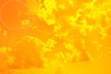 Image of Orange sky with clouds during hot summer weather