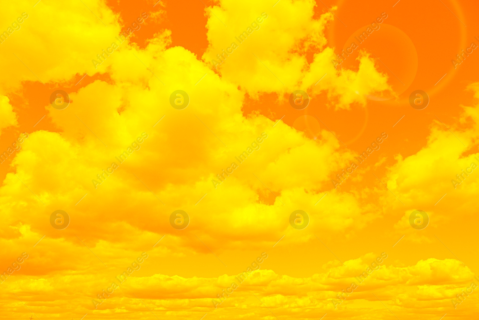 Image of Orange sky with clouds during hot summer weather