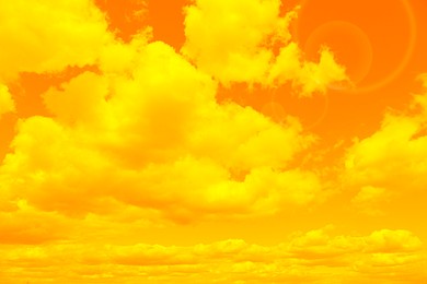 Image of Orange sky with clouds during hot summer weather