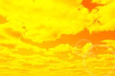 Image of Orange sky with clouds during hot summer weather