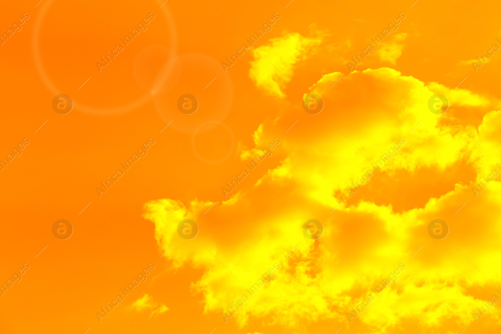 Image of Orange sky with clouds during hot summer weather