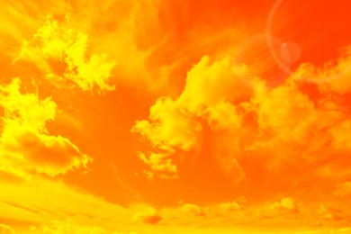 Image of Orange sky with clouds during hot summer weather